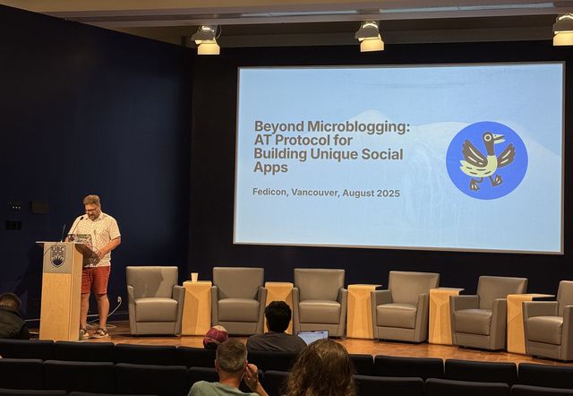 Photo of the stage at FediCon 2025. Boris Mann is giving a talk.